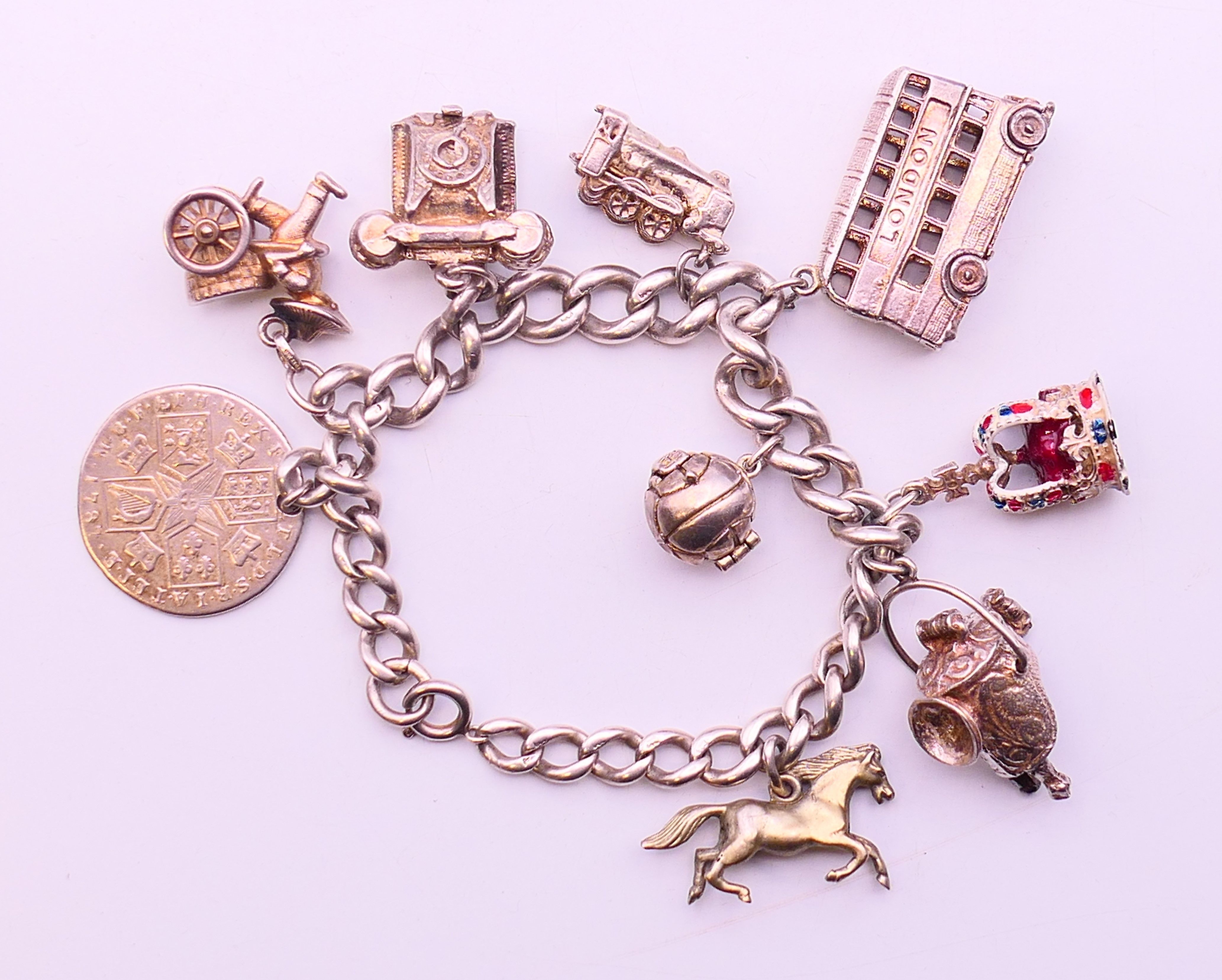 A silver charm bracelet and charms. Approximately 20 cm long. 75.6 grammes total weight. - Image 2 of 4