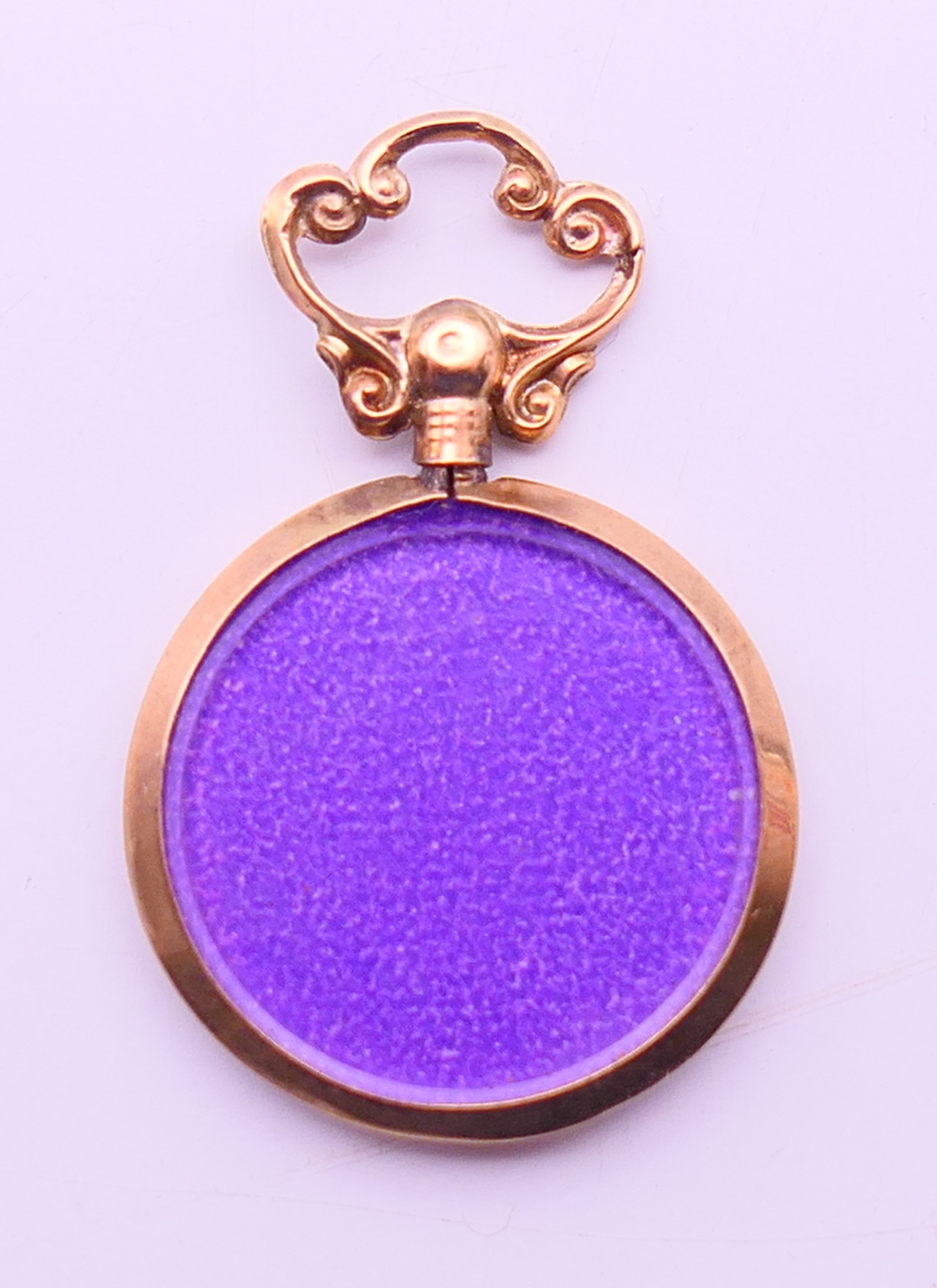 A 9 ct gold double photo locket pendant. 3.5 cm high including suspension loop.