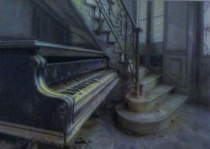 A gilt-framed staircase and piano photographic print, glazed. 39.5 x 28 cm.