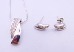 An 18 ct white gold and diamond pendant on an 18 ct white gold chain and a pair of 9 ct gold and