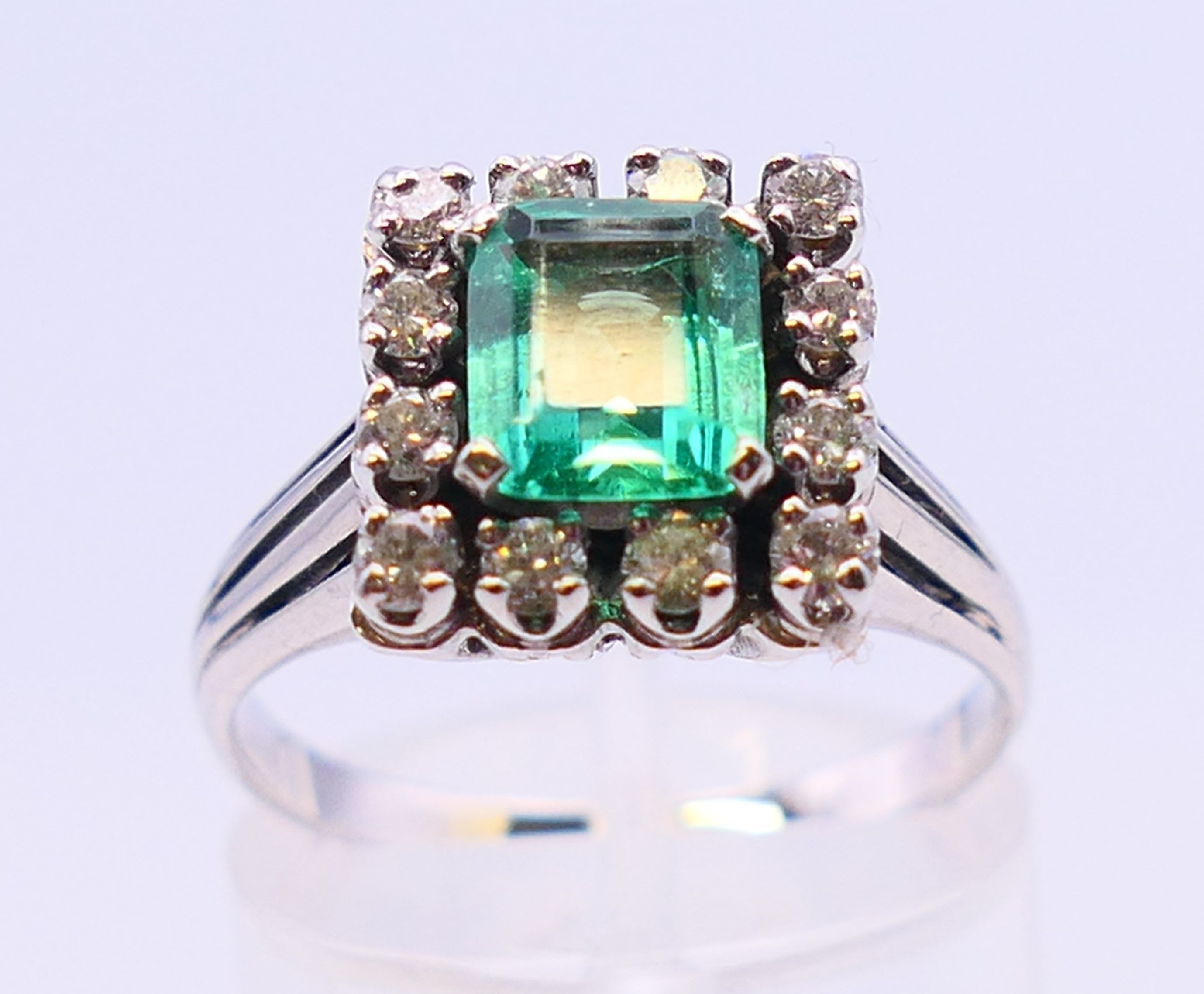An unmarked 18 ct white gold, emerald and diamond ring. Ring size N/O. - Image 2 of 6