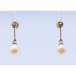 A pair of 9 ct gold, diamond and pearl earrings. 2 cm high.