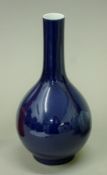 A Chinese blue ground porcelain straight neck vase. 25 cm high.