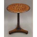 A 19th century inlaid tripod table. 52 cm diameter.