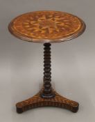 A 19th century inlaid tripod table. 52 cm diameter.