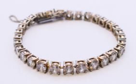 A silver and cubic zirconia bracelet. Approximately 18 cm long.