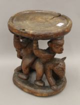 A late 19th/early 20th century African Yoruba Tribe stool/ceremonial table. 37.5 cm high.