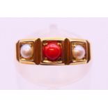 An antique 18 ct gold, pearl and coral ring. 4 grammes. Ring size L/M.