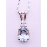 A 14 ct white gold aquamarine diamond pendant on a 14 K white gold chain.