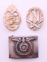 A WWII German belt buckle and two awards. Buckle 6.5 x 5 cm.