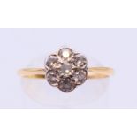 A transitional cut diamond seven stone cluster ring, estimated 0.40 ct, SI, tested gold 18 ct.