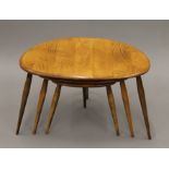 A nest of three Ercol pebble coffee tables. 46 cm wide.