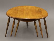 A nest of three Ercol pebble coffee tables. 46 cm wide.
