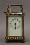 A brass-cased carriage clock (in working order). 14.5 cm high.