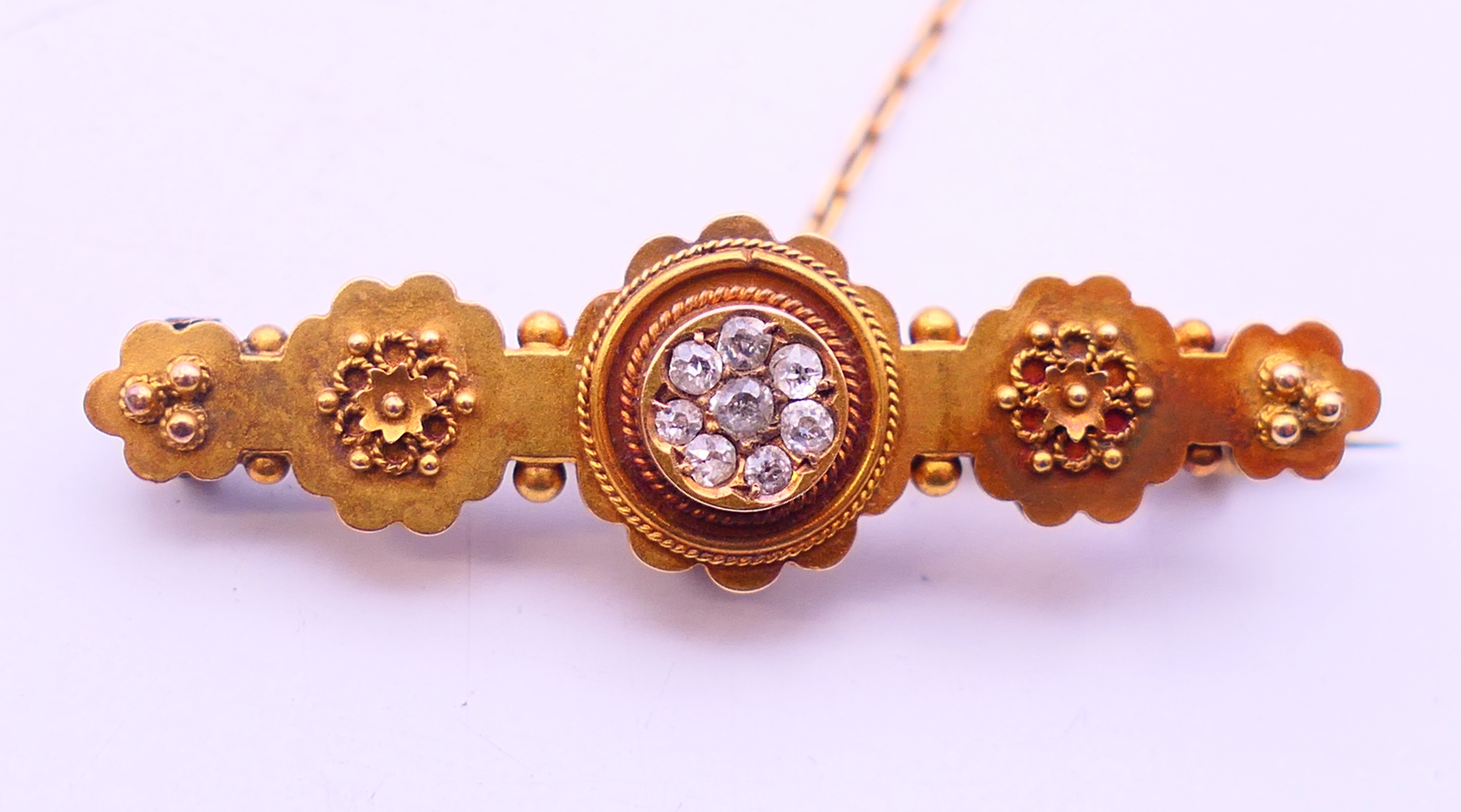A 15 ct gold and diamond brooch. 4 cm long. 3 grammes total weight.