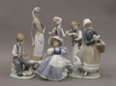 Four Lladro figurines and two Nao figurines. The largest 27.5 cm high.