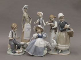 Four Lladro figurines and two Nao figurines. The largest 27.5 cm high.