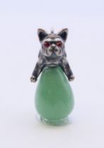 A jade pendant in the form of a dog astride an egg, bearing Russian marks. 3 cm high.
