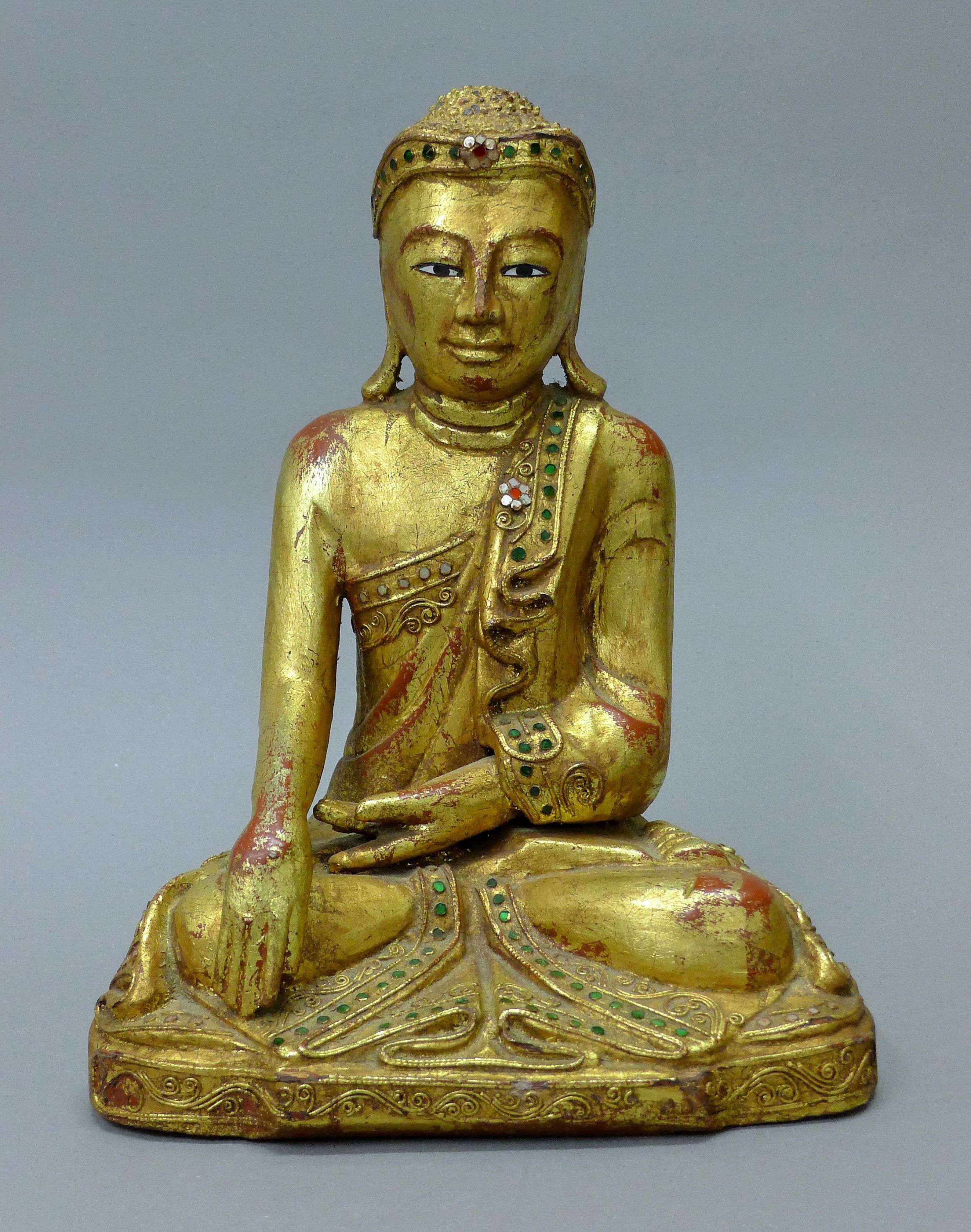 A gilt wood model of Buddha. 33 cm high.