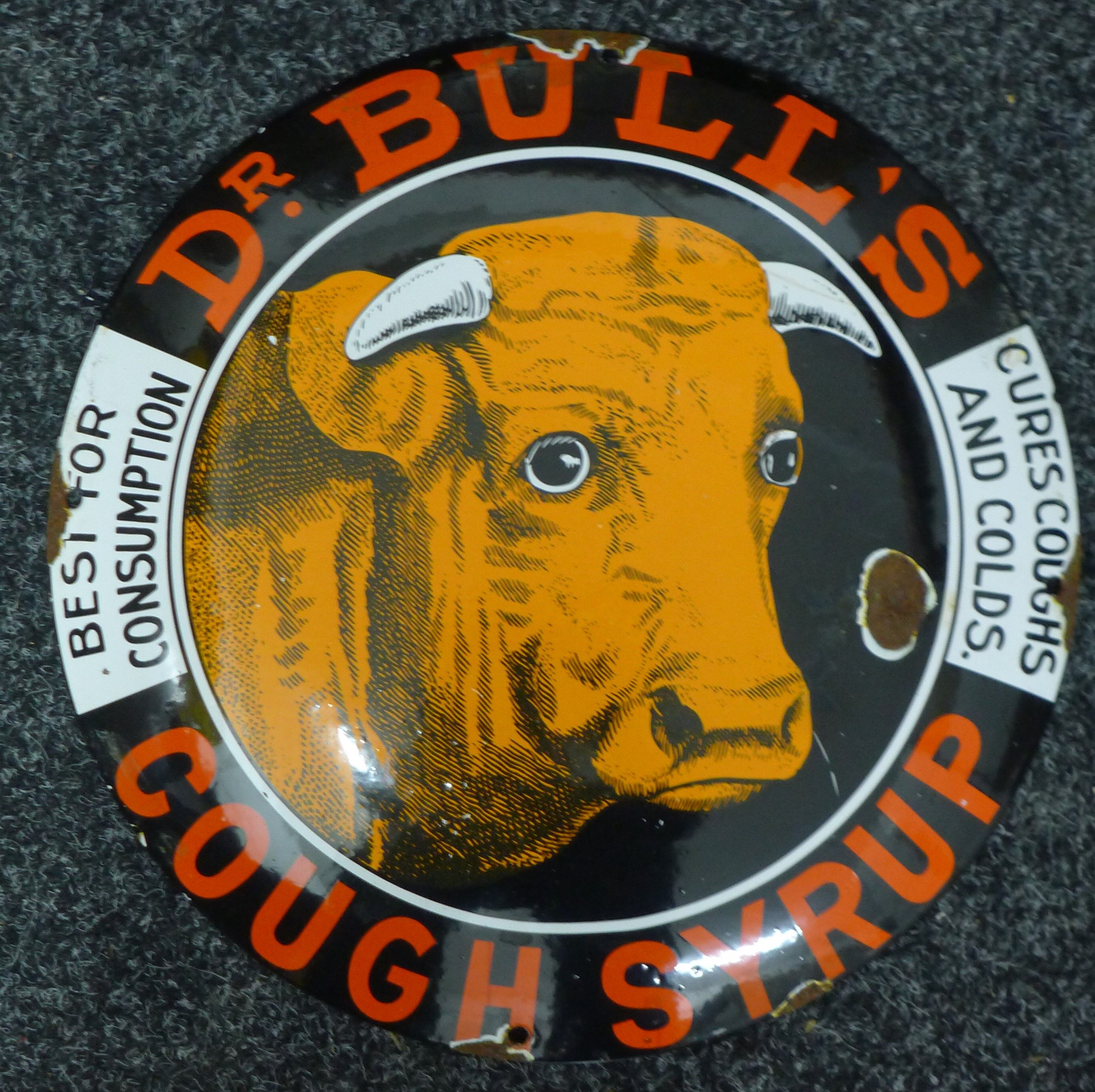 A Doctor Bull's Cough Syrup enamel sign. 29 cm diameter.