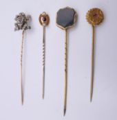 Three gold stick pins and another formed as a frog. Frog stick pin 6.5 cm high (frog 1.5 cm high).