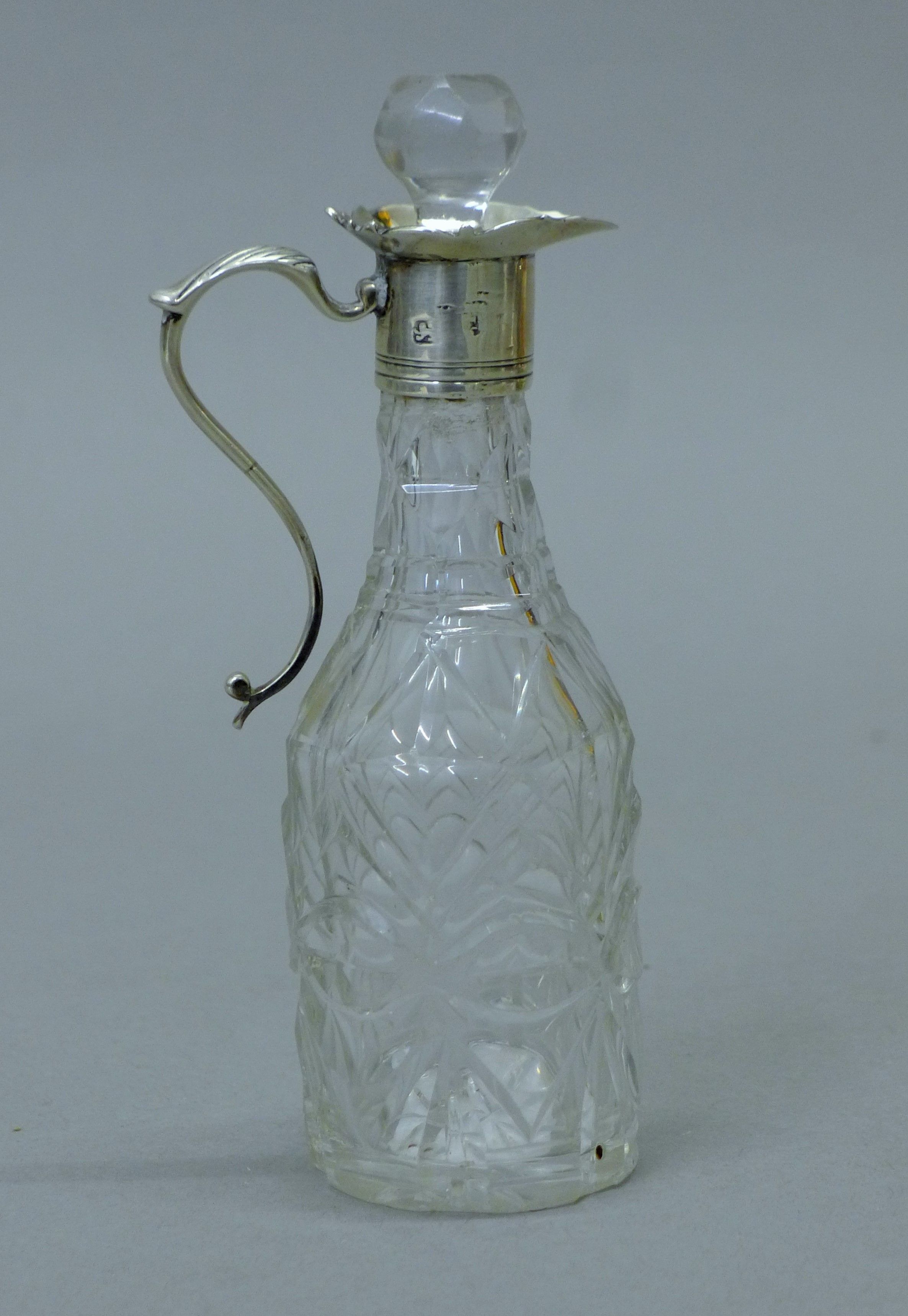 Two silver top cut glass oil and vinegar bottles, both with English silver marks. The tallest 14. - Image 2 of 7