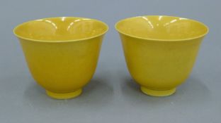 A pair of Chinese yellow ground porcelain cups. Each 5.75 cm high.