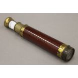 A Victorian wood and brass two-draw telescope. 32.5 cm long extended.