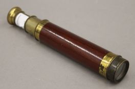 A Victorian wood and brass two-draw telescope. 32.5 cm long extended.