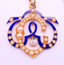 An unmarked, diamond, enamel and seed pearl set pendant on a 9 ct gold chain. Pendant 2.