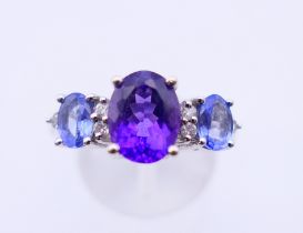 A 14 ct white gold, amethyst and topaz ring. 4.9 grammes. Ring size Q/R.