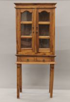 A modern glazed cabinet on stand. 66 wide x 153 cm high.