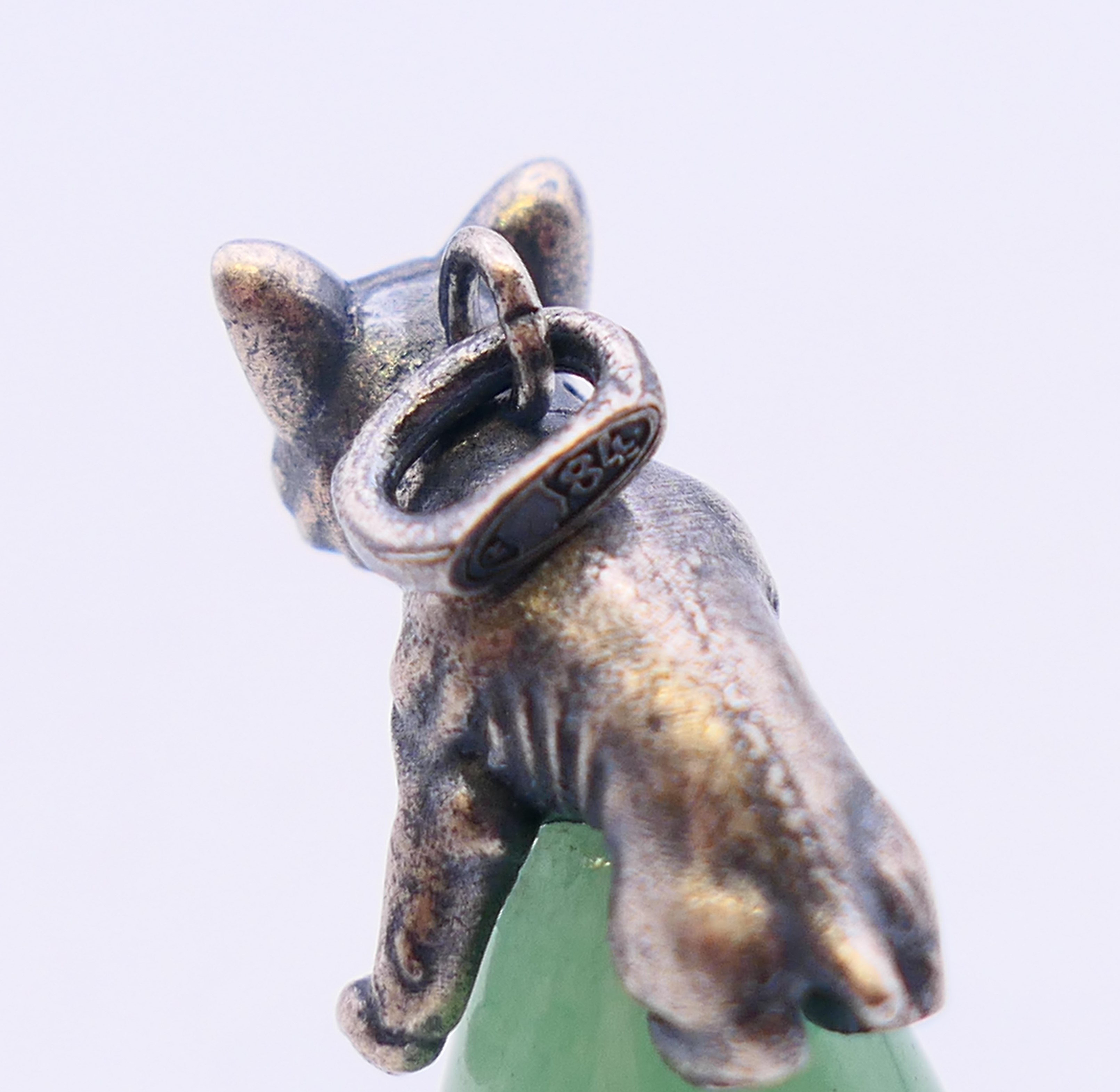 A jade pendant in the form of a dog astride an egg, bearing Russian marks. 3 cm high. - Image 4 of 4
