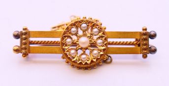 A boxed seed pearl and unmarked gold brooch. 4 cm wide. 5.3 grammes total weight.