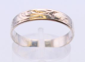 A silver wedding band stamped 925. Ring size S.