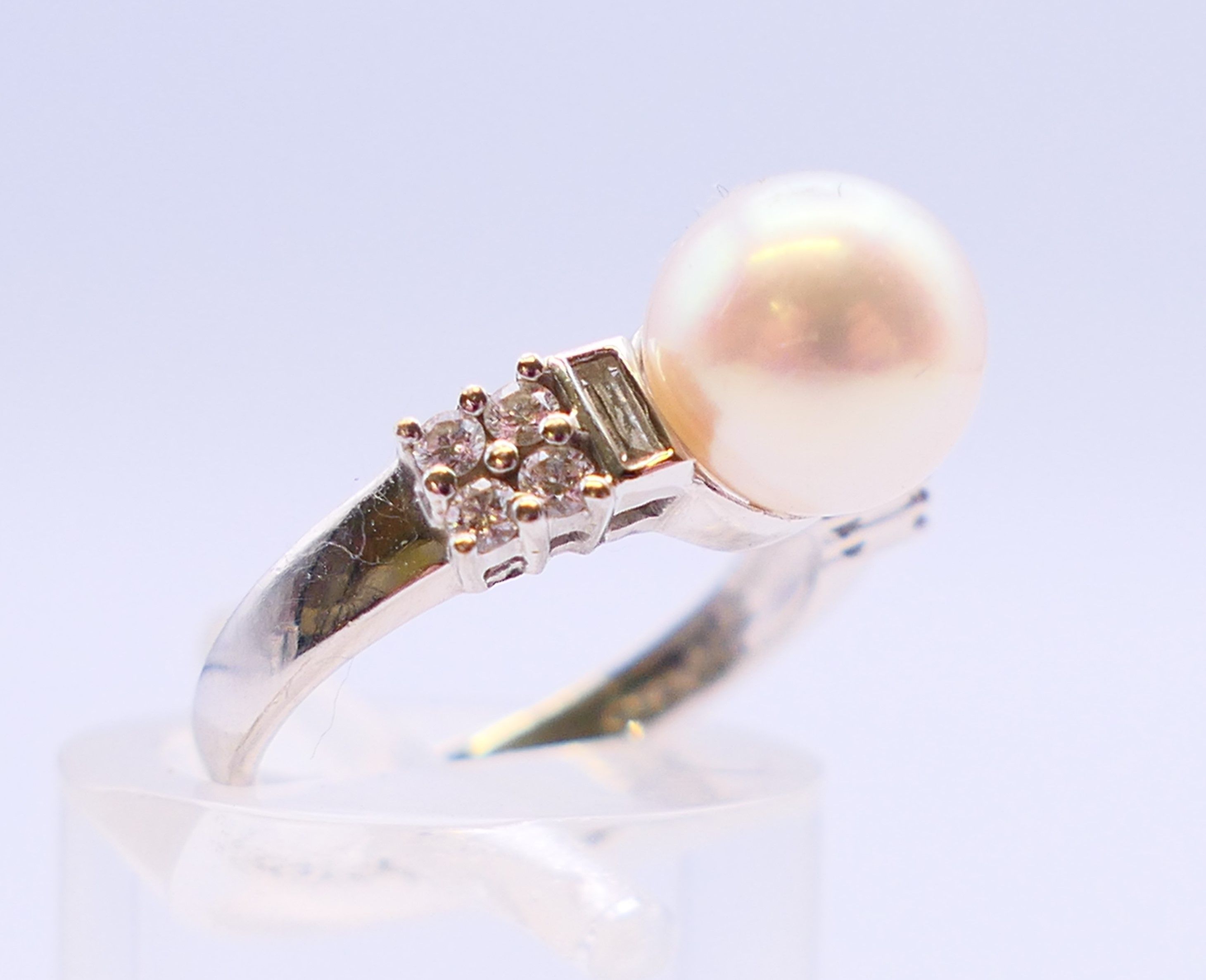 An 18 ct white gold and pearl ring flanked by baguette cut and round diamonds. Ring size I. - Image 3 of 6