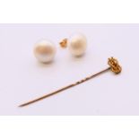 A 15 ct gold mounted stickpin and a pair of 9 ct gold and pearl earrings. Earrings 1.25 cm diameter.
