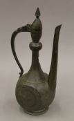 An antique Indo-Persian copper ewer with decorated side panels. 36 cm high.
