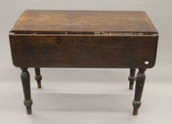 A mahogany Pembroke table. 56 cm wide flaps down.