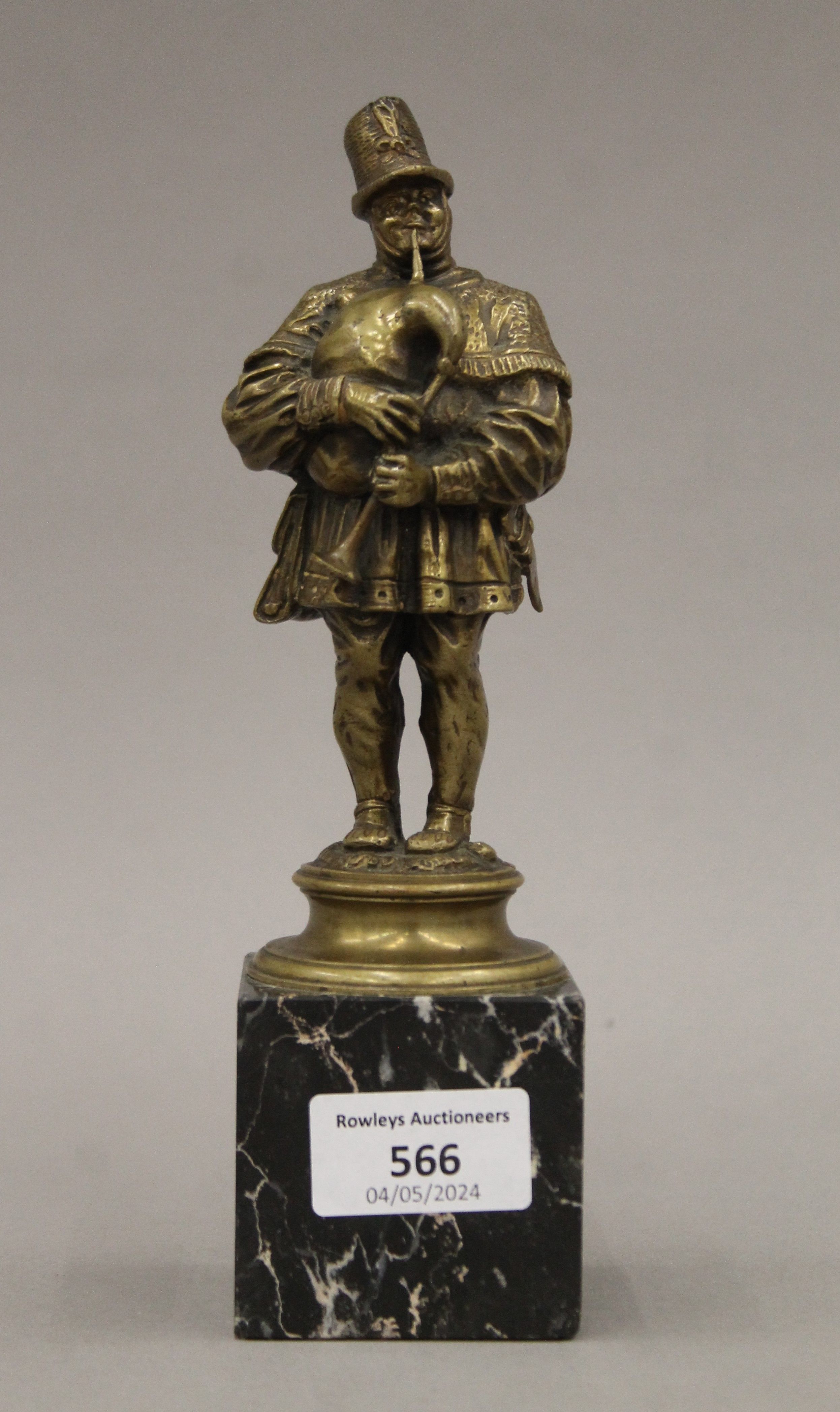 A 19th century gilt bronze figure of a bagpiper on a marble base. 21.5 cm high overall.