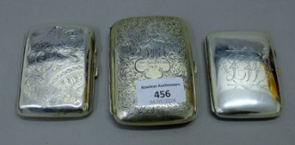 Three silver cigarette cases. The largest 10 cm long. 235.2 grammes total weight.