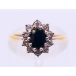 An 18 ct gold sapphire cluster ring. Ring size K.