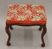 A 19th century tapestry-covered stool. 54 cm long.
