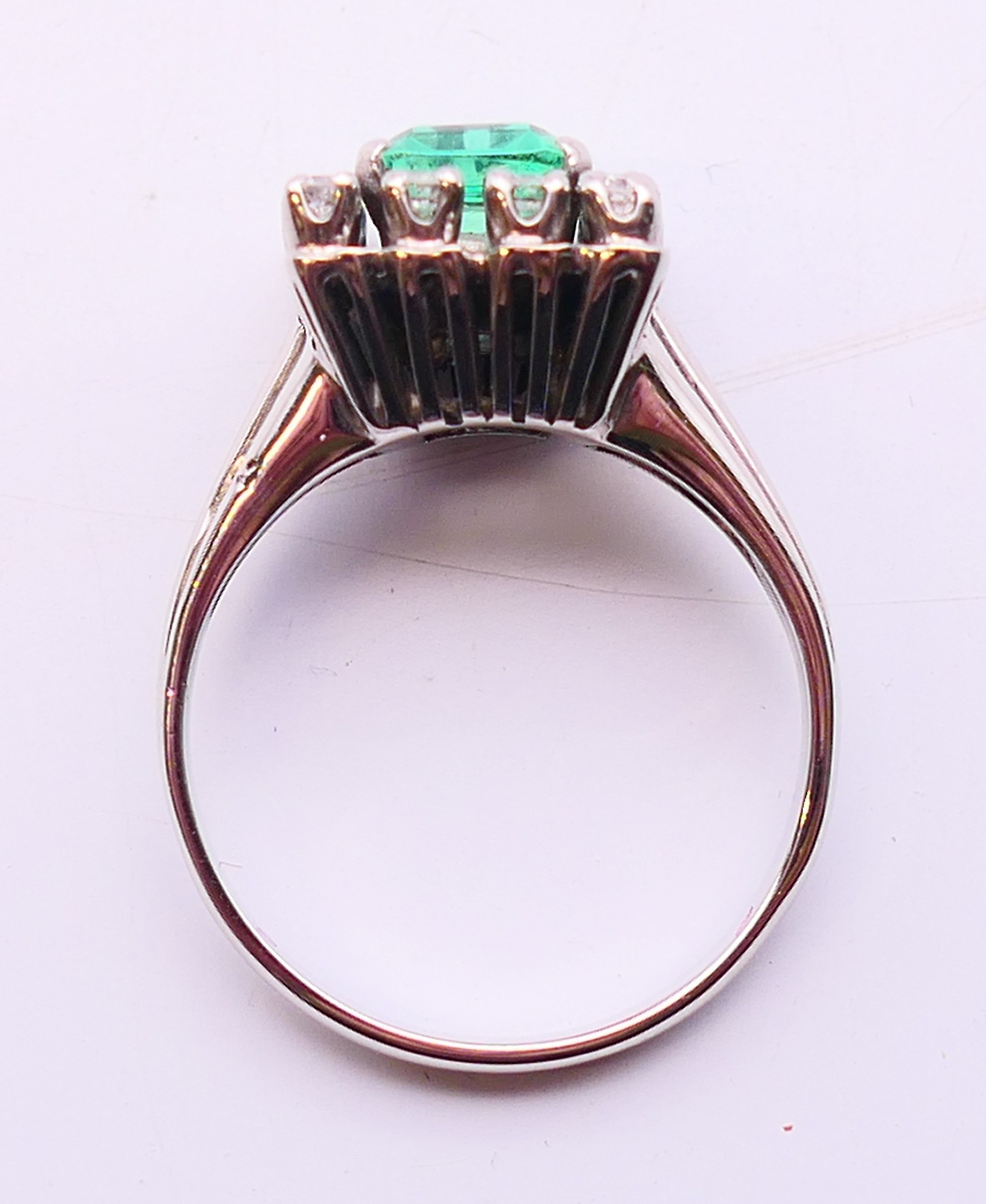 An unmarked 18 ct white gold, emerald and diamond ring. Ring size N/O. - Image 6 of 6