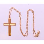 A gold cross pendant on a 10 K gold chain. Cross 4 cm high, chain 47 cm long. 4 grammes.