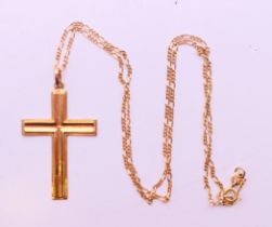 A gold cross pendant on a 10 K gold chain. Cross 4 cm high, chain 47 cm long. 4 grammes.
