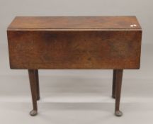 An oak drop-leaf table with pad feet. 32.5 cm wide flaps down.