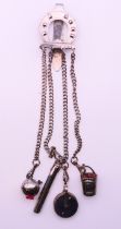 A 19th century steel chatelaine consisting of four implements on chains leading to a horseshoe