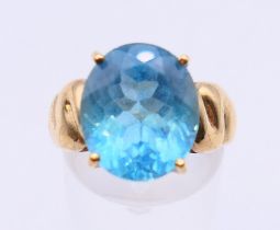 A 9 ct gold Swiss blue topaz ring with certificate of authenticity stating 8.640 ct, 5.