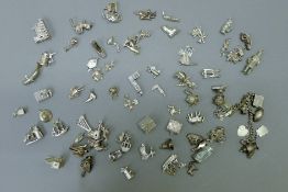 A quantity of silver charms. 8.7 troy ounces total weight.